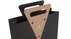 Koehler Brilliant Black paper and SH recycled brown paper riveted die-cut handle hot foiled logo