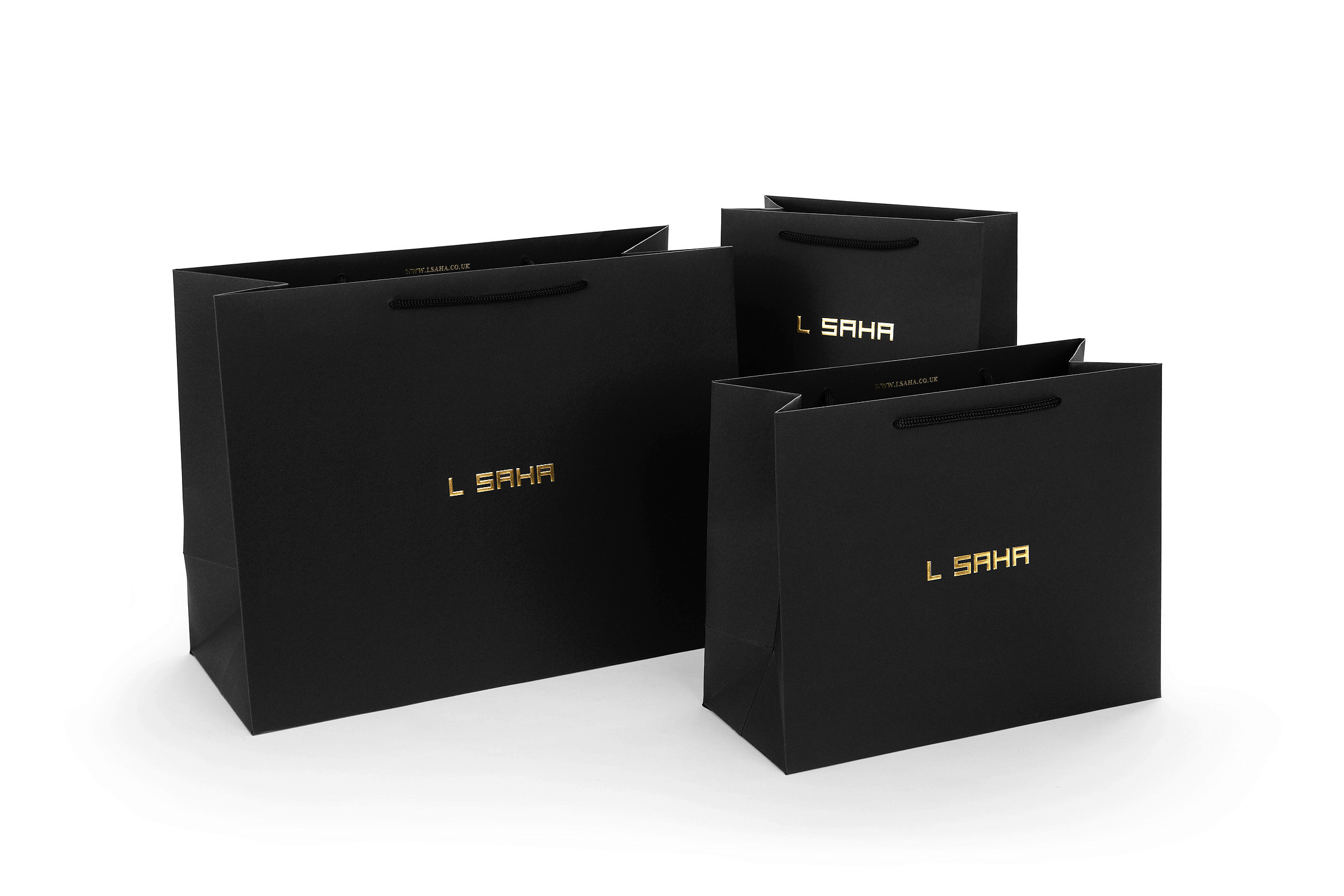premium rope handle paper bags in different sizes from recycled material with gold foil blocking over black paper